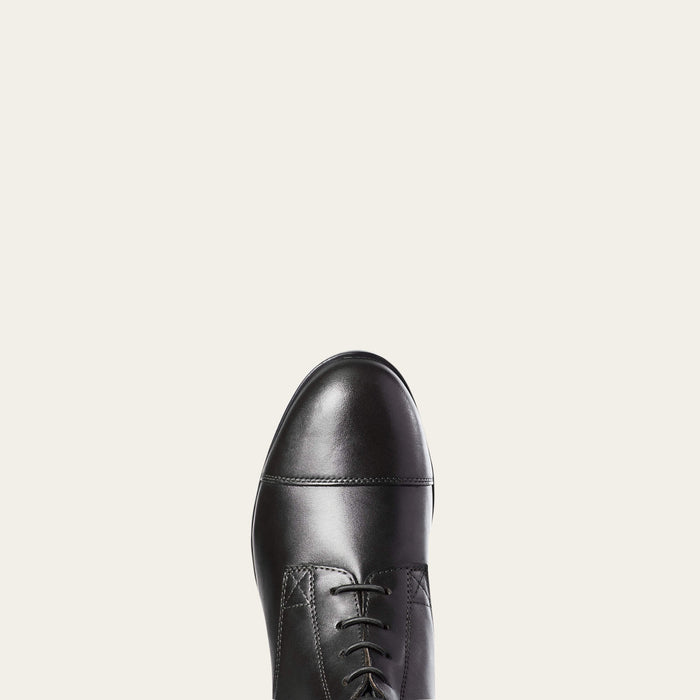 Black leather dress shoe on a light gray background
