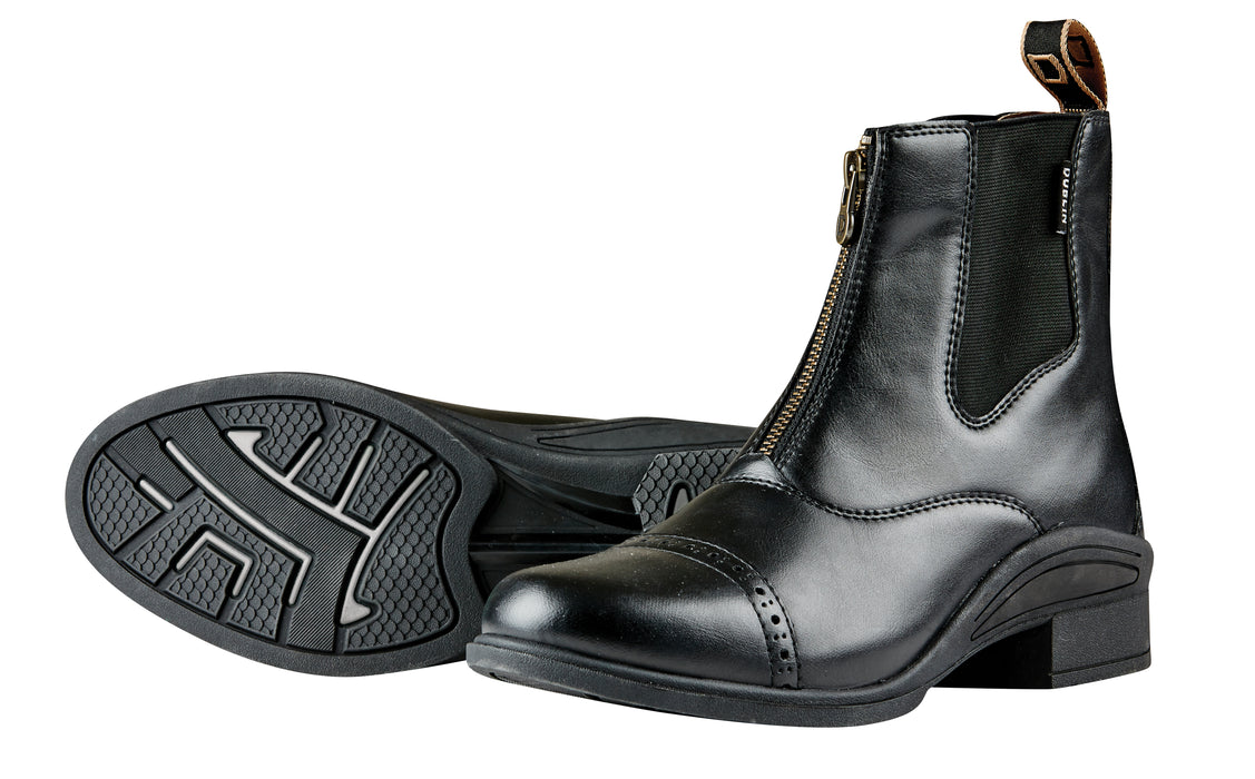 Pair of black leather paddock riding boots, with a front zipper and pull on the back of the boot. Rubber sole with low heal on a white background.