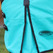 A close-up of a turquoise horse blanket shoulder gusset with black trim and straps, featuring the WeatherBeeta logo on the lower right, shown on a horse outdoors.