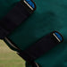 Close-up of a dark forest green  waterproof neck rug with two black WeatherBeta strap closures and the WeatherBeta logo patch visible on each strap.