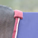 Close-up of a horse wearing a navy turnout blanket with burgundy and white piping. Showing the Fleece fabric added at the neck for wither protection. 