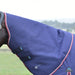 A navy blue horse turnout blanket with burgundy and white piping, shown on a horse outdoors with a blurred grassy field in the background.