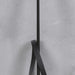 A black riding crop with a textured grip handle and a black leather loop, shown against a light gray textured background.