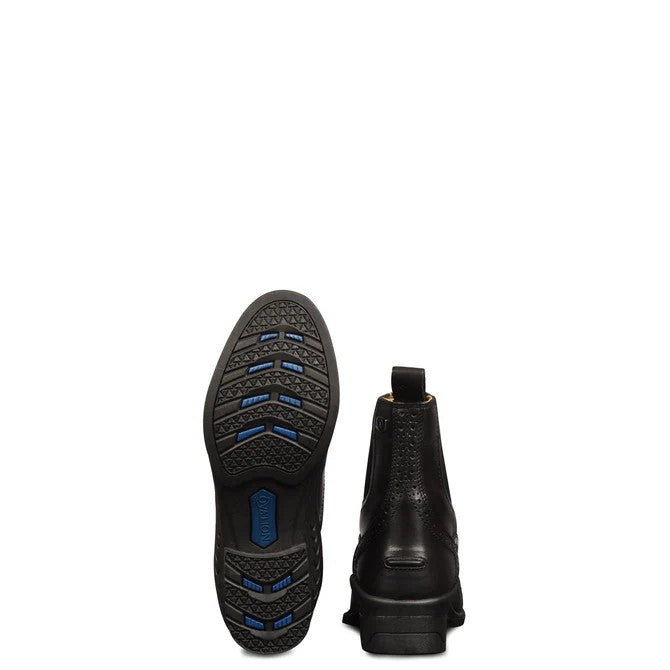 A pair of black leather paddock boots shown from the back, displaying the textured black rubber outsole with blue accents and the back profile of the boot against a solid white background.