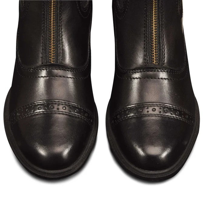 Close-up of black leather boots with a gold zipper on a white background