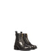 Brown paddock riding boots with circle punch detailing on the toe, side gussets, zipper closure and pull tab on the back. Black rubber sole with short heal on a white background.