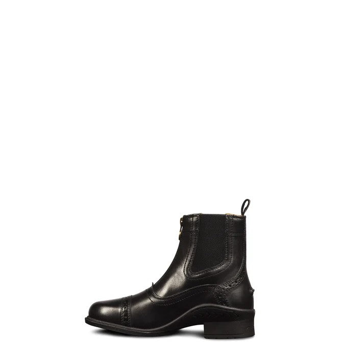 Black paddock riding boot with circle punch detailing on the toe, side gussets, zipper closure and pull tab on the back. Black rubber sole with short heal on a white background.
