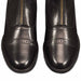 Pair of black leather paddock riding boots with gold zippers on a white background