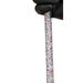 A close-up of a hand wearing a black glove holding the shaft of a riding crop with a speckled white handle and black rubber tips.