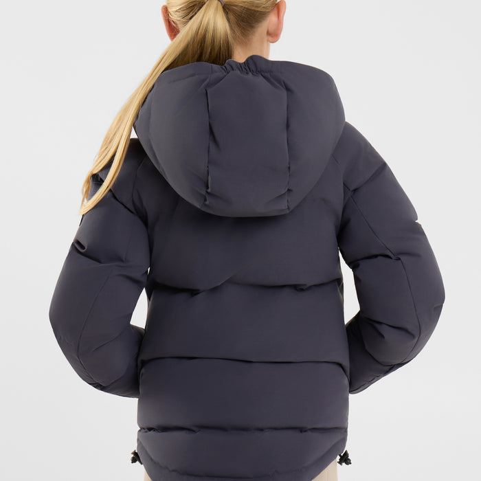 A child wearing a dark navy blue hooded puffer jacket, shown from the back against a light gray studio background.