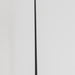 A long black riding dressage whip or whip with a curved hook-like tip, standing upright on a light wood floor against a plain white wall.