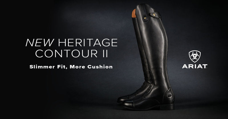 A single black Ariat tall riding boot shown on a dark studio background with promotional text reading 'NEW HERITAGE CONTOUR II' and 'Slimmer Fit, More Cushion.' The Ariat logo is visible on the right.
