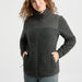 A dark gray fleece zip-up jacket with a textured heathered body and a smoother zippered yoke panel, shown on a plain white background.