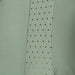 Green fabric with a row of small holes along one edge