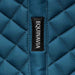 Close-up of a blue quilted sadddle pad  with 'Equinavia' label on the spine